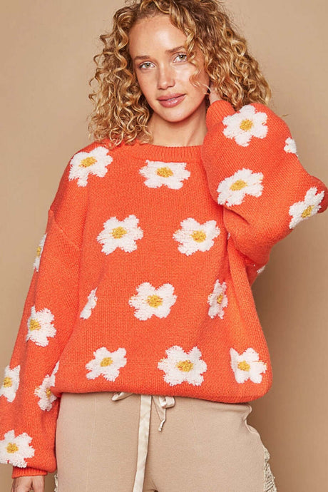 Woman wearing orange drop shoulder Daisy Sweater with playful daisy design and relaxed fit, perfect for women's winter clothes.